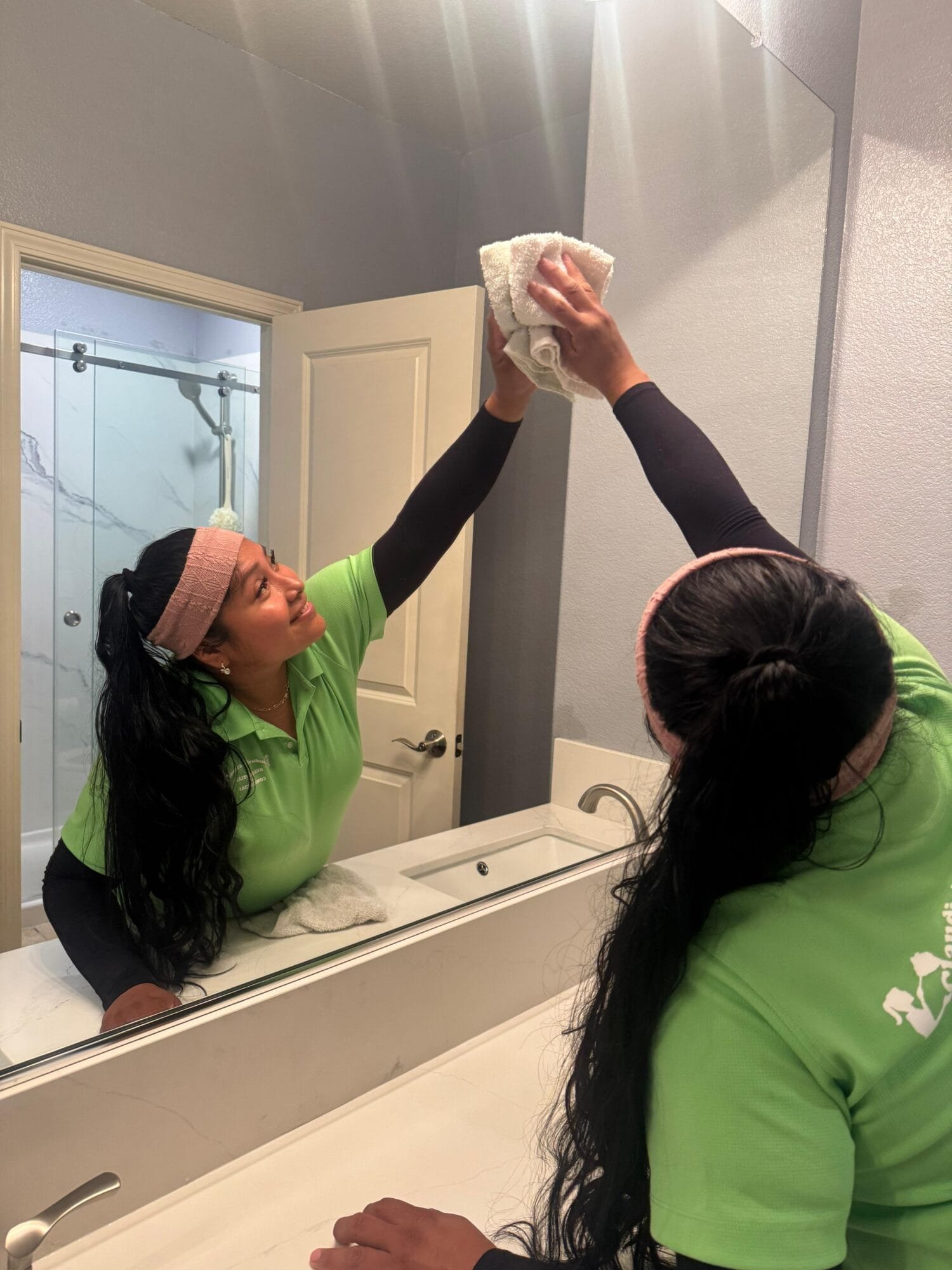 Professional cleaners wiping interior glass during a deep cleaning service in Carmichael, CA