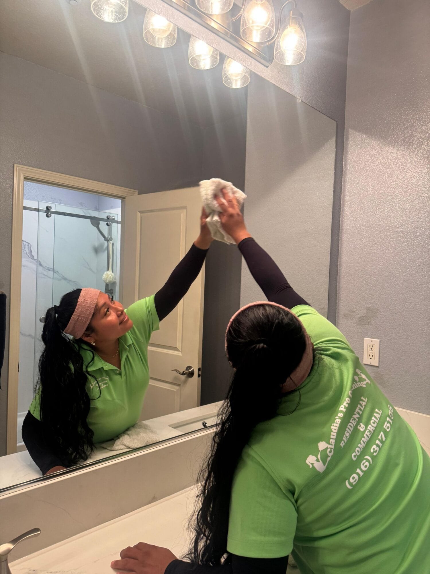 Recurring house cleaning technician cleaning ceiling fan in South Land Park Sacramento CA