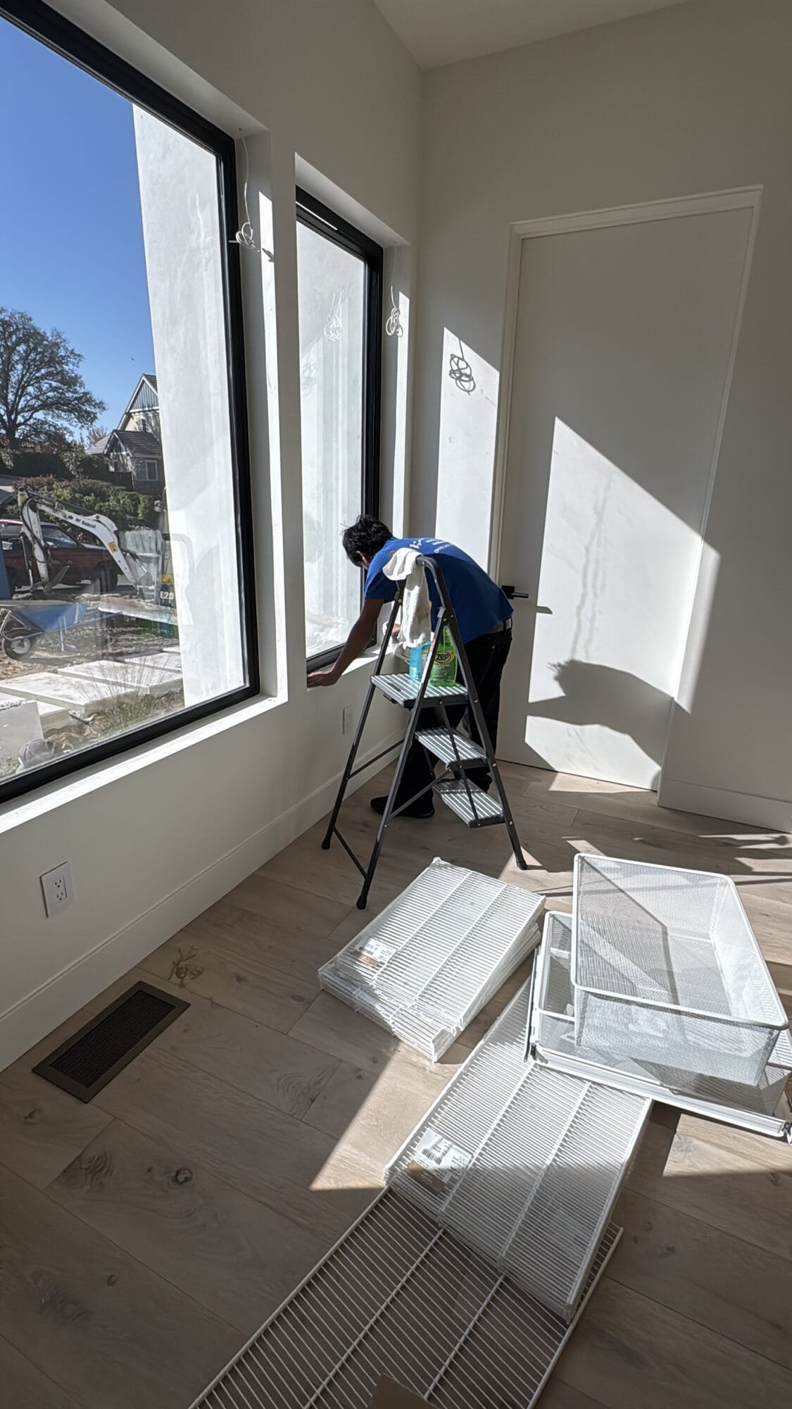 Professional post construction cleaning technician cleaning staircase after renovation in Rocklin, CA
